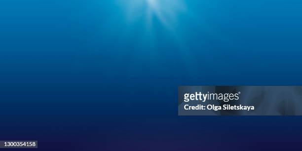 abstract blue background with rays of light - 海中　光 ストックフォトと画像