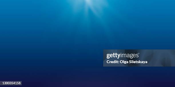 abstract blue background with rays of light - underwater stock pictures, royalty-free photos & images