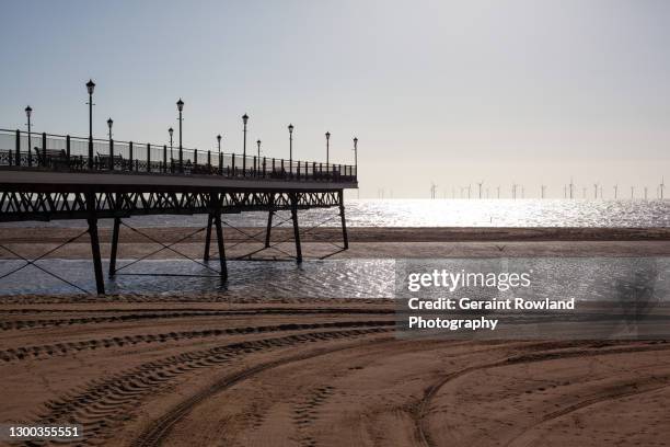 skegness pier at low tide. - skegness stock pictures, royalty-free photos & images