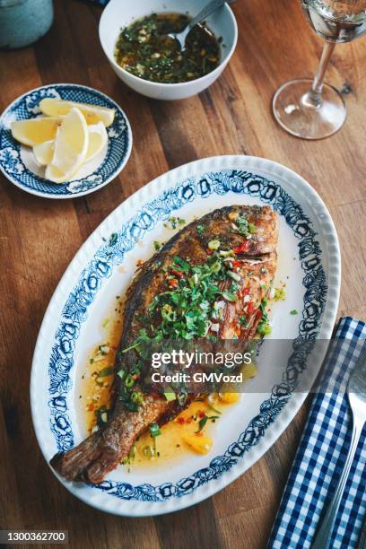 grilled sea beam with mojo isleno puerto rican sauce - mojo stock pictures, royalty-free photos & images