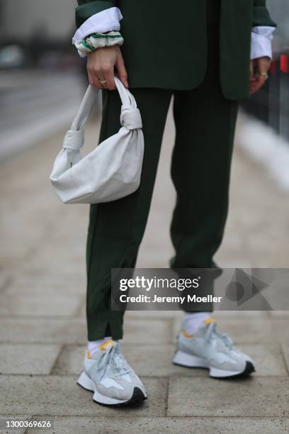 Louisa Theresa Grass wearing green Nakd suit, New Balance sneaker and beige Bottega Veneta bag on February 02, 2021 in Hamburg, Germany.