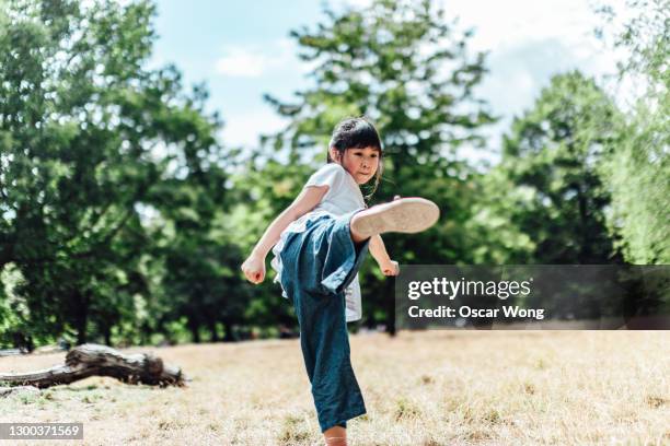 teenage girl practicing martial art in park - hong kong lifestyle society health stock pictures, royalty-free photos & images