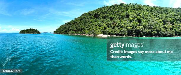 a panoramic view of the ocean and some island. - parati stock pictures, royalty-free photos & images