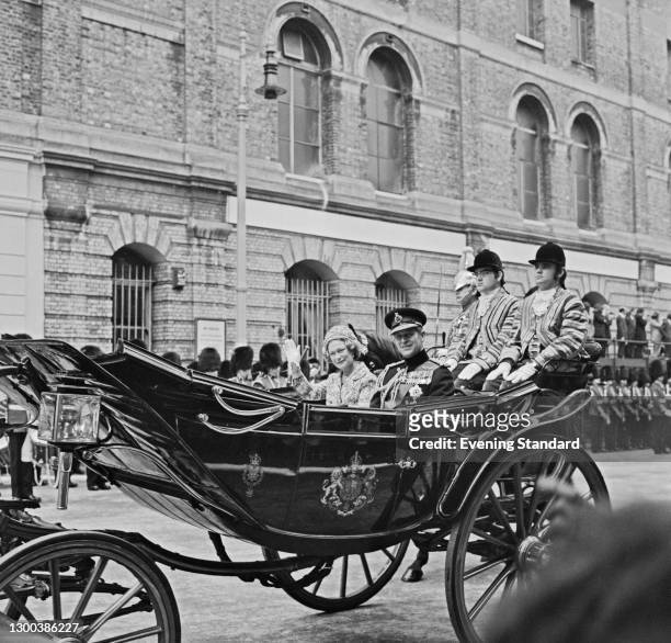 Grand Duchess Joséphine-Charlotte of Luxembourg travels in a coach with Prince Philip, Duke of Edinburgh, during a visit to London with her husband,...