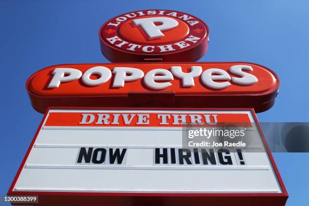 Now Hiring' sign is posted in front of a Popeye's restaurant on February 04, 2021 in Miami, Florida. The Labor Department announced weekly...