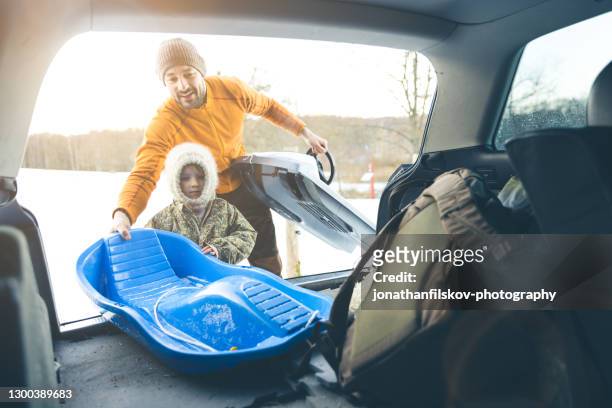 snow adventure with sled - knitted car stock pictures, royalty-free photos & images