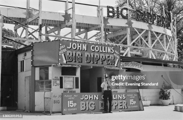 Police officer in front of the John Collins Big Dipper roller coaster at Battersea Park Fun Fair in London, after an accident resulted in the deaths...