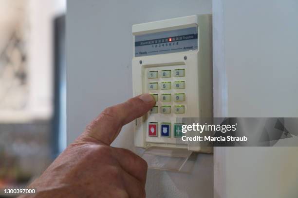 man's hand punching code into security system - burglar alarm stock pictures, royalty-free photos & images