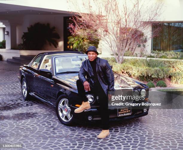 Former Heavyweight Champion boxer Mike Tyson at his home in 2000 with his Jaguar and Bentley in Las Vegas, Nevada.