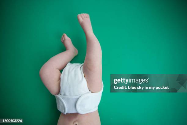 a 3 month old baby's legs wearing a washable nappy - reusable diaper stock pictures, royalty-free photos & images