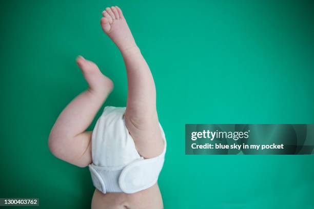 a 3 month old baby's legs wearing a washable nappy - reusable diaper stock pictures, royalty-free photos & images