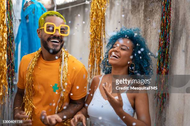 couple throwing confetti at carnival - fiesta stock pictures, royalty-free photos & images