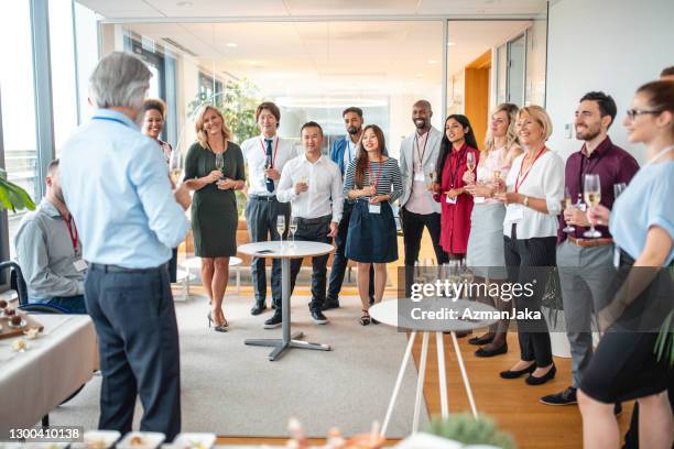 ceo making toast at office social gathering - launch party inside stock pictures, royalty-free photos & images