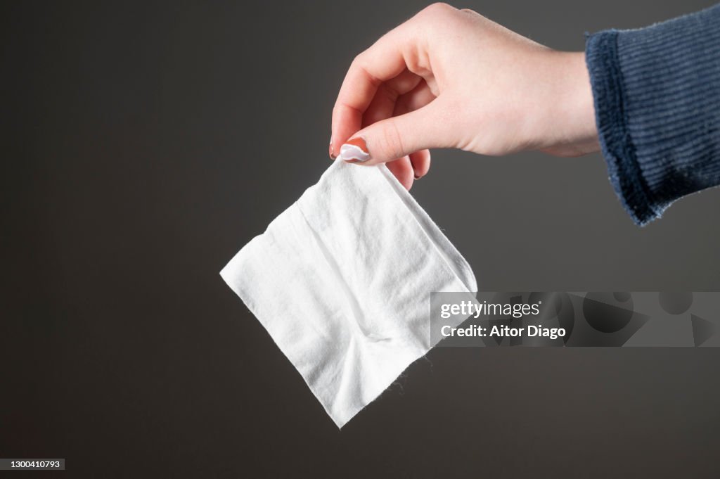 Jung woman holding in her hand a waterwipe.