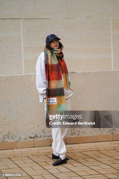 Gabriella Berdugo wears a Calvin Klein outfit made of beige sweat / jogger sportswear pants and a white oversized sweat shirt, white socks, Gucci...