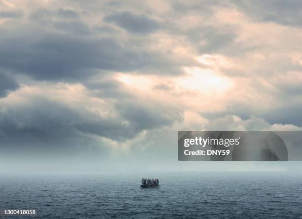 group of business people stranded on a  boat - universal salvation stock pictures, royalty-free photos & images