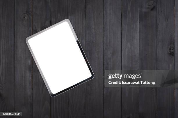 digital tablet computer with isolated screen on old wooden desk - desk tablet phone monitor stock pictures, royalty-free photos & images