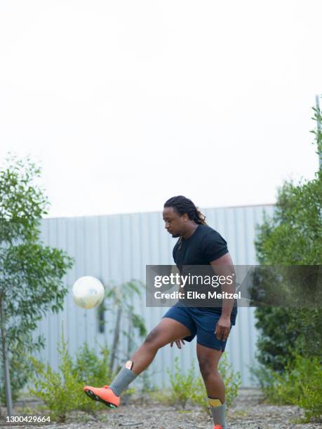 man playing soccer - fat soccer players stock pictures, royalty-free photos & images