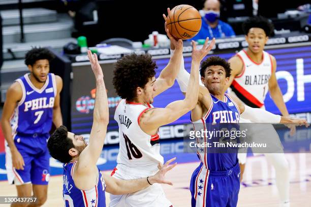 Elleby of the Portland Trail Blazers and Matisse Thybulle of the Philadelphia 76ers reach for the ball during the third quarter at Wells Fargo Center...