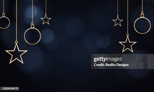 hanging golden starts and balls on dark background - christmas decoration lights stock illustrations