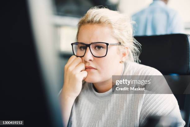 blond businesswoman working on computer at office - frustration icon stock pictures, royalty-free photos & images