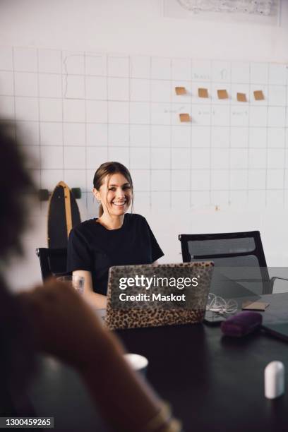 smiling female entrepreneur with laptop in it startup company - business casual dress code stock pictures, royalty-free photos & images