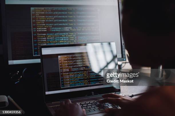 young female engineer coding over laptop in it startup company - computer programmer stock pictures, royalty-free photos & images