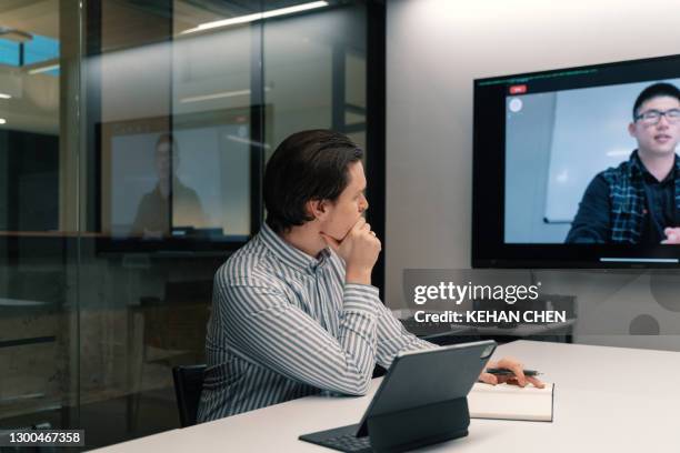 young businessman have a online meeting with colleague in office - two people video conferencing stock pictures, royalty-free photos & images