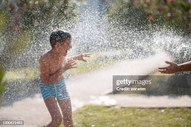 Water Getting Sprayed Kid Being Sprayed With Water High-Res Stock Photo - Getty Images