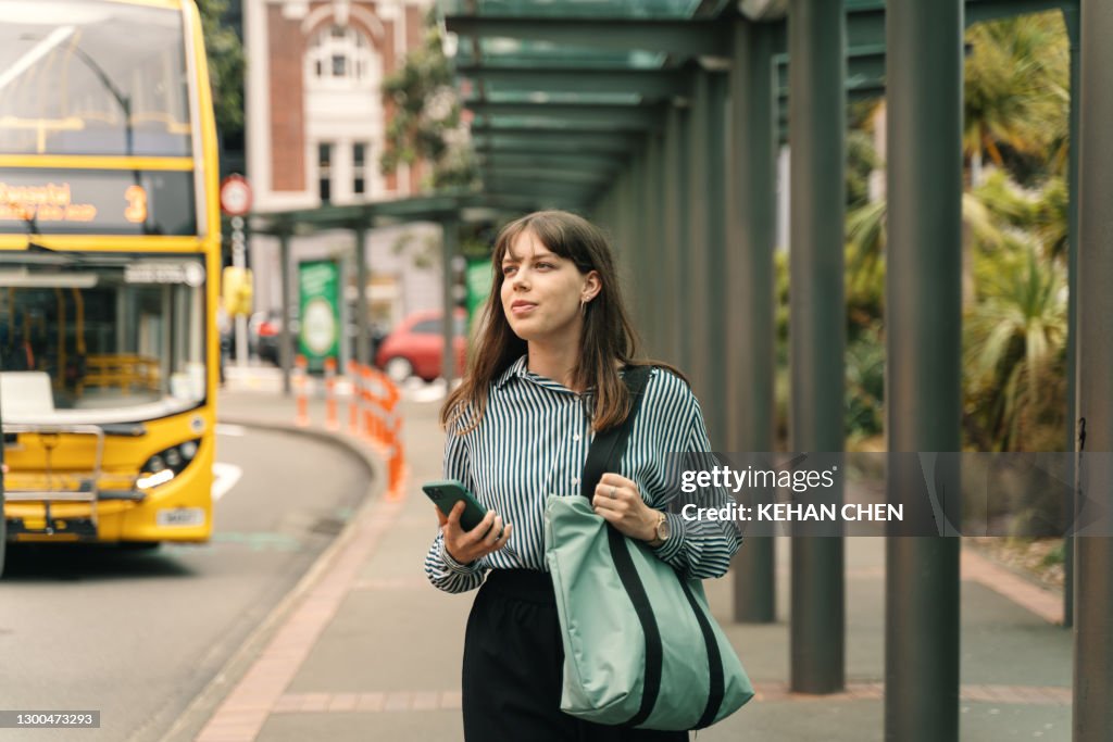 Young businesswoman walking in the bus station