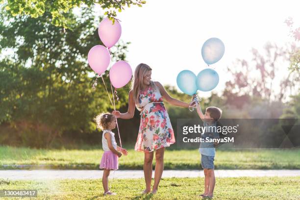 pregnant mother and her children sharing love - gender reveal stock pictures, royalty-free photos & images