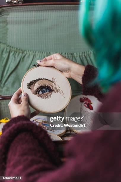 midsection of young woman placing embroidery frames in suitcase - embroidery frame stock pictures, royalty-free photos & images