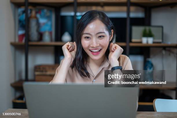 happy young indian business woman entrepreneur using computer looking at screen working in internet sit at office desk, smiling female professional employee typing email on laptop at workplace - bid offer stock pictures, royalty-free photos & images