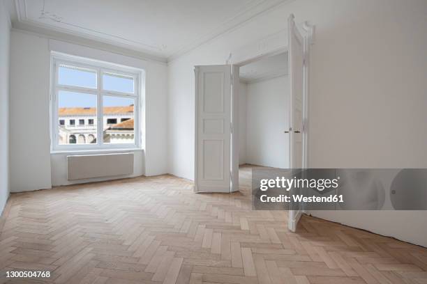 open doors inside new renovated apartment - fischgrat stock-fotos und bilder
