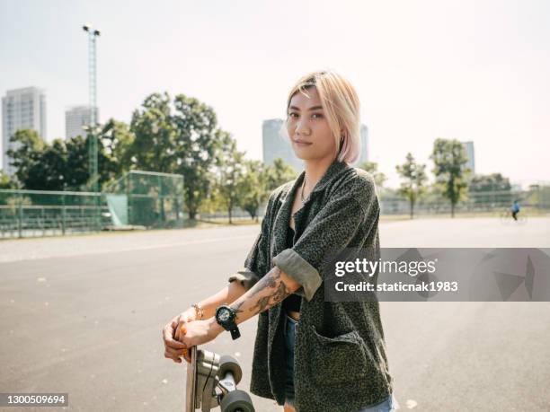 teen girl with longboard in the skateboard park. - cool attitude youth stock pictures, royalty-free photos & images