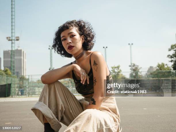 adolescente con monopatín en el parque en un día soleado. - estilo de vida alternativo fotografías e imágenes de stock