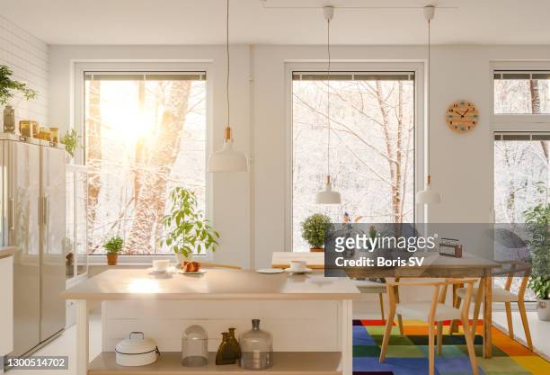 morning sun streaming into the kitchen, winter scene - cosy stock-fotos und bilder