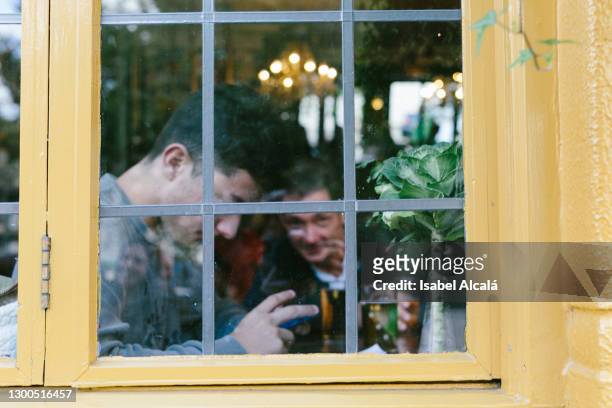 young man with his father in a pub in - cosy pub stock pictures, royalty-free photos & images