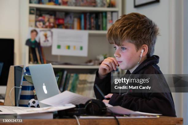 Year-old boy, the photographer's son, continues home schooling online via a laptop, on January 11, 2021 in Bath, United Kingdom. Under current...