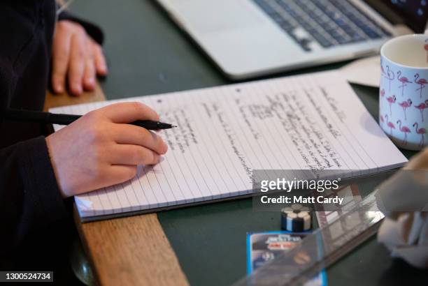 Year-old boy, the photographer's son, continues home schooling online via a laptop, on January 11, 2021 in Bath, United Kingdom. Under current...