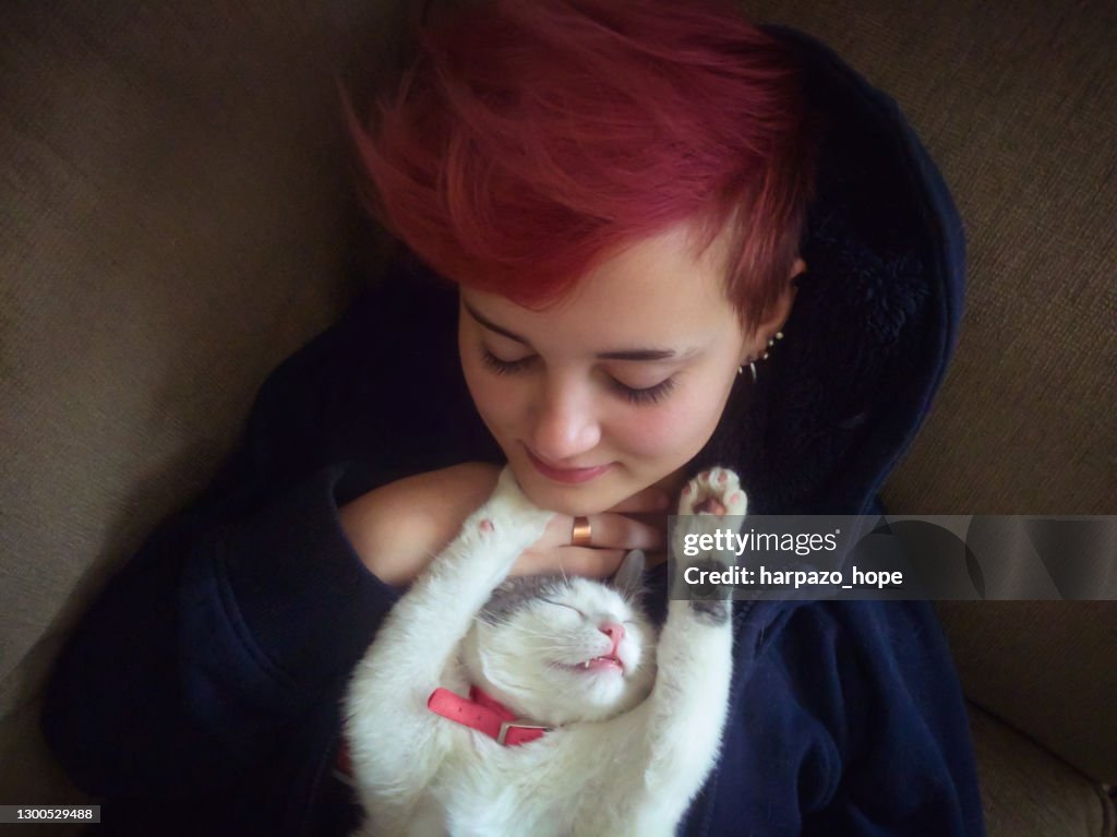 Cat stretched out and sleeping on her owner.