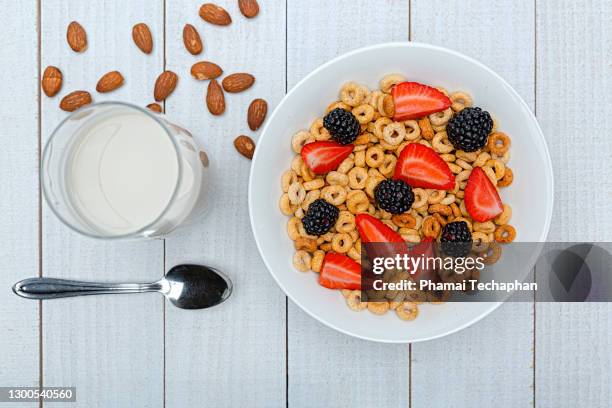 a bowl of cereal loops and a glass of milk with fresh fruit - cheerios stock pictures, royalty-free photos & images