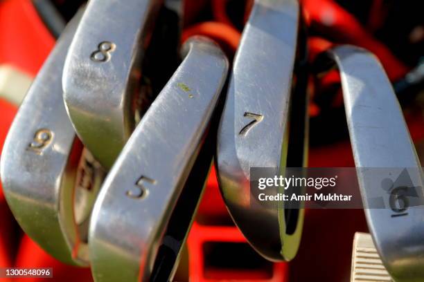 closeup of golf clubs with numbers in golf bag. - luxury club stock pictures, royalty-free photos & images