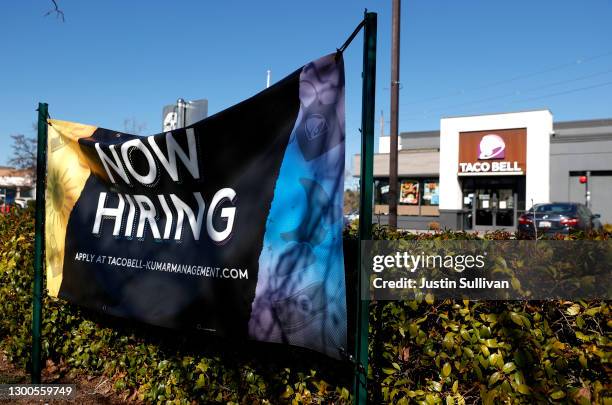 Now hiring sign in posted in front of a Taco Bell restaurant on February 05, 2021 in Novato, California. The U.S. Added 49,000 jobs in January,...