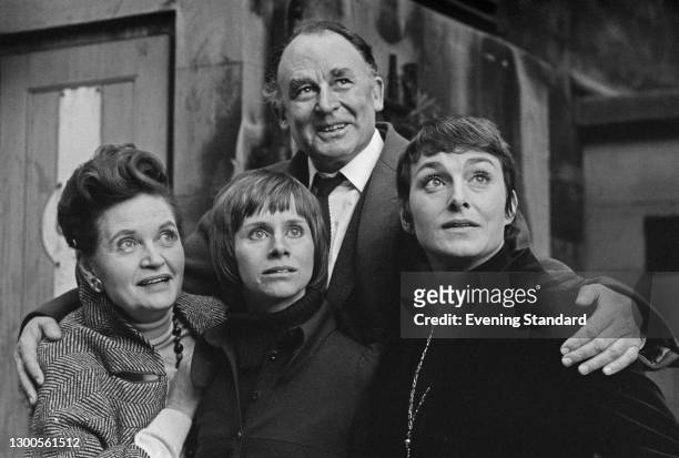 Actor Geoffrey Keen embraces fellow actors Margaretta Scott, Rita Tushingham and Barbara Jefford, UK, 12th February 1973. They are appearing together...