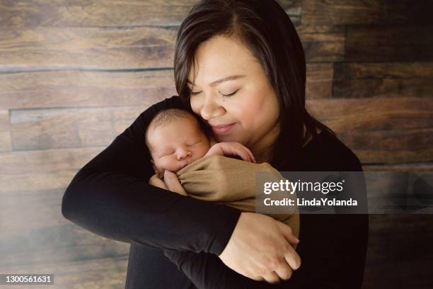 mother holding newborn - indian mother stock pictures, royalty-free photos & images