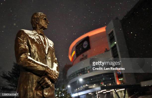 Snow falls on the statue of former Philadelphia Flyers owner and COO Ed Snider prior to the Flyers playing the New York Islanders at the Wells Fargo...