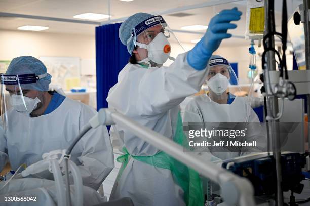 Staff at University Hospital Monklands attend to a Covid-positive patient on the ICU ward on February 5, 2021 in Airdrie, Scotland. The numbers of...