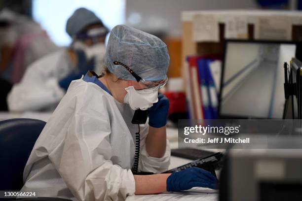 Member of staff at University Hospital Monklands makes a telephone call on the ICU ward on February 5, 2021 in Airdrie, Scotland. The numbers of...