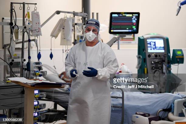 Member of staff at University Hospital Monklands attends to a Covid-positive patient on the ICU ward on February 5, 2021 in Airdrie, Scotland. The...